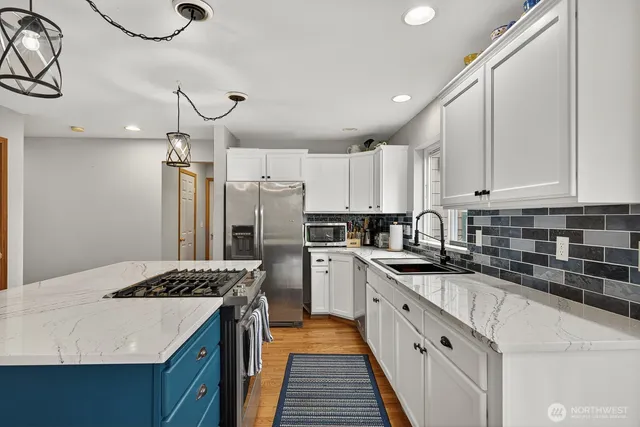 a kitchen with a sink stove and refrigerator