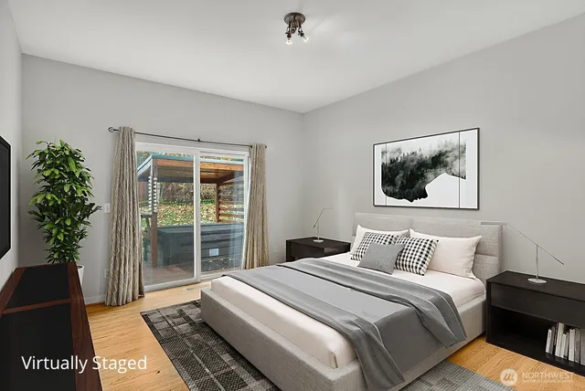 a bedroom with a large bed and a potted plant