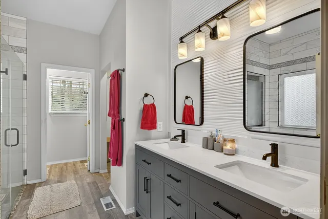 a bathroom with a sink vanity and a mirror