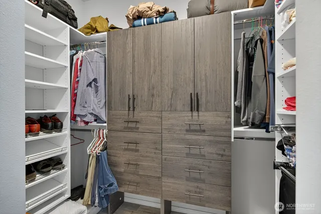 a view of walk in closet with clothes