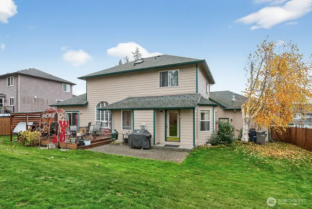 a view of a house with backyard and a patio