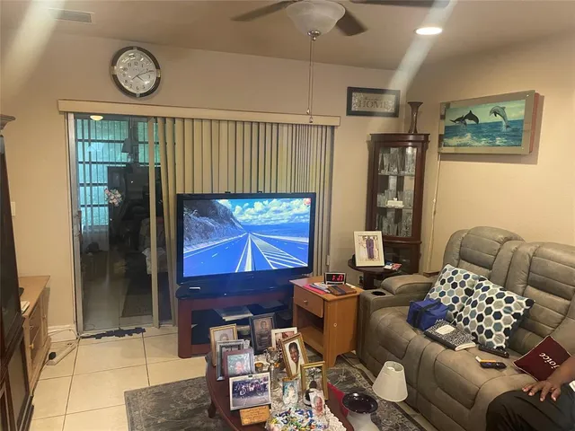 a living room with furniture a rug and a window