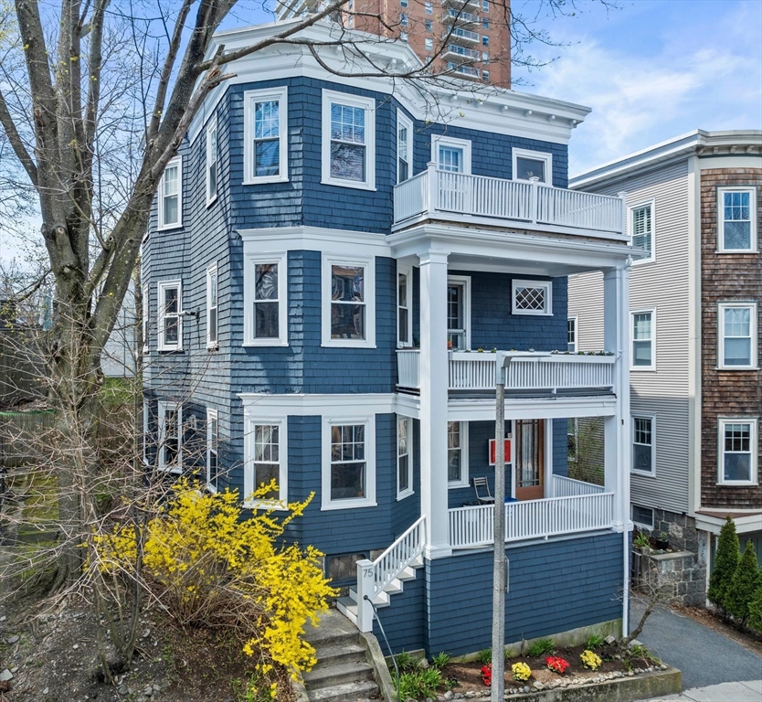 a front view of a residential apartment building with a yard