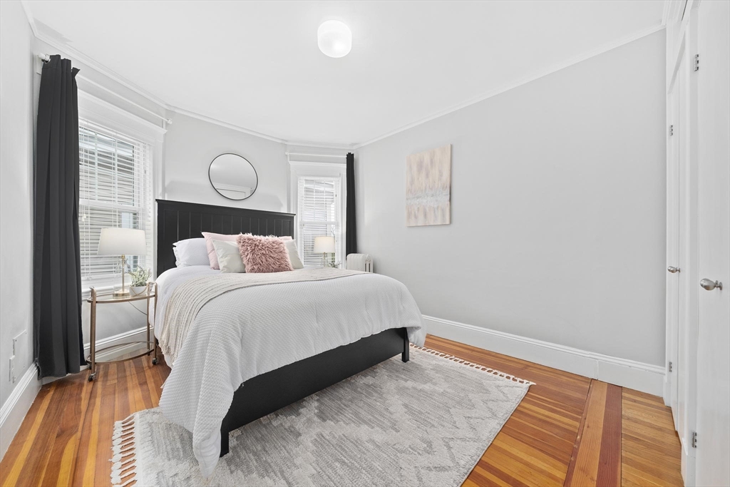 75 Parkton Road, Unit 3 Boston, MA 02130 - Photo 13 of 40 a bedroom with a bed and wooden floor