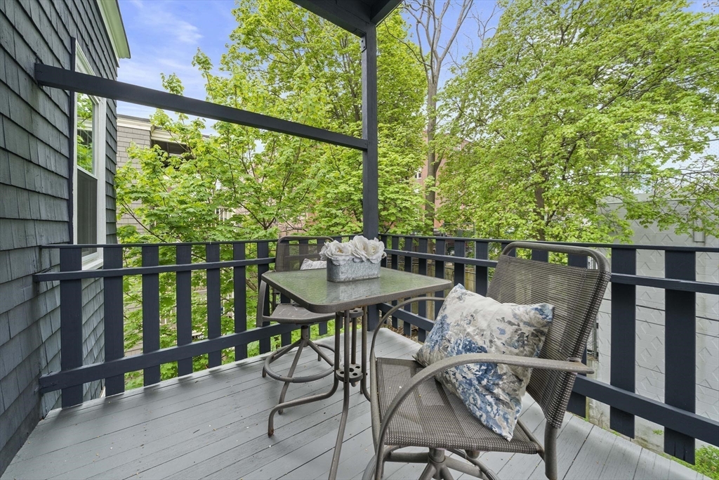 75 Parkton Road, Unit 3 Boston, MA 02130 - Photo 20 of 40 a balcony with wooden floor table and chairs