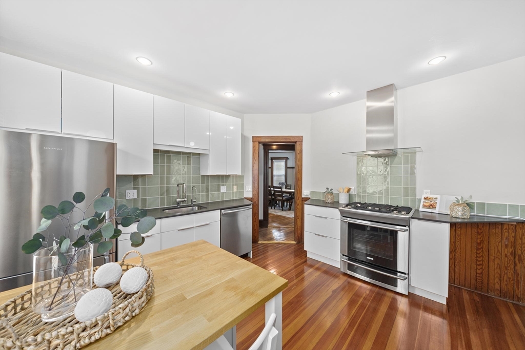 75 Parkton Road, Unit 3 Boston, MA 02130 - Photo 8 of 40 a kitchen with stainless steel appliances granite countertop a stove refrigerator and cabinets