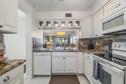 a kitchen with cabinets and window
