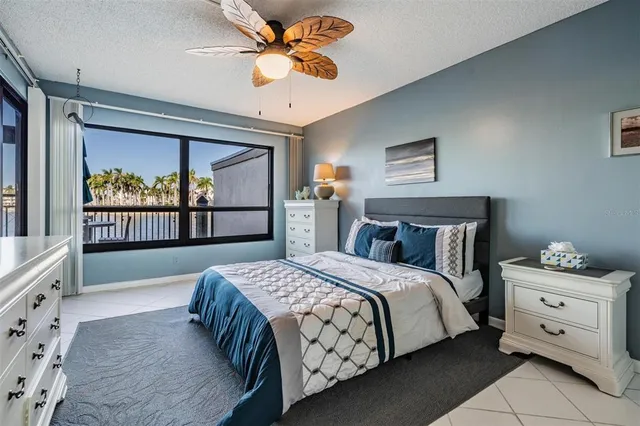 a bedroom with a bed and a large window