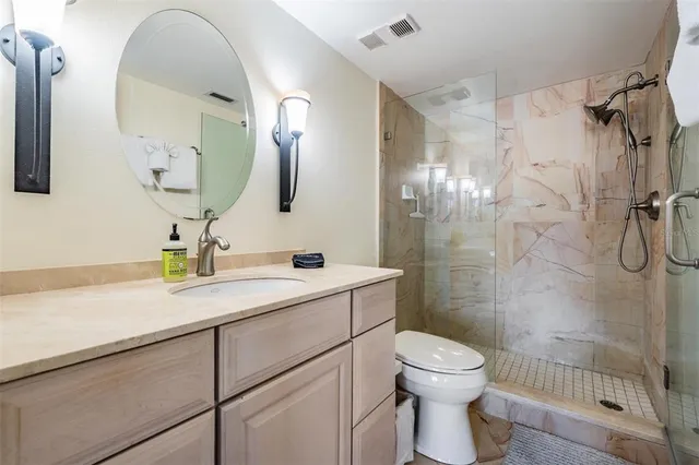 a bathroom with a toilet sink and shower