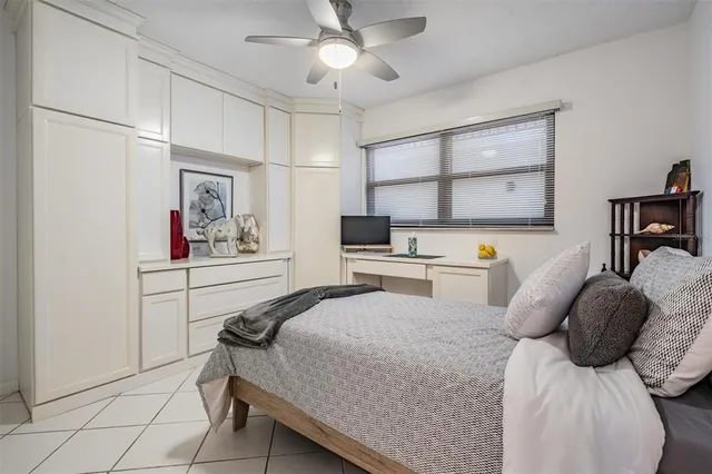 a bedroom with a bed a large window and wall painting