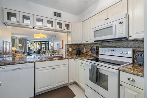 a kitchen with cabinets appliances and a sink