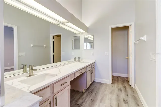 a bathroom with a sink a mirror and a bathtub