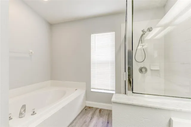 a bathroom with a bathtub and a shower