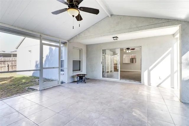 a view of a livingroom with a ceiling fan and window