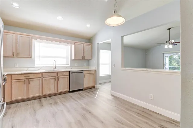a large kitchen with kitchen island white cabinets and wooden floor