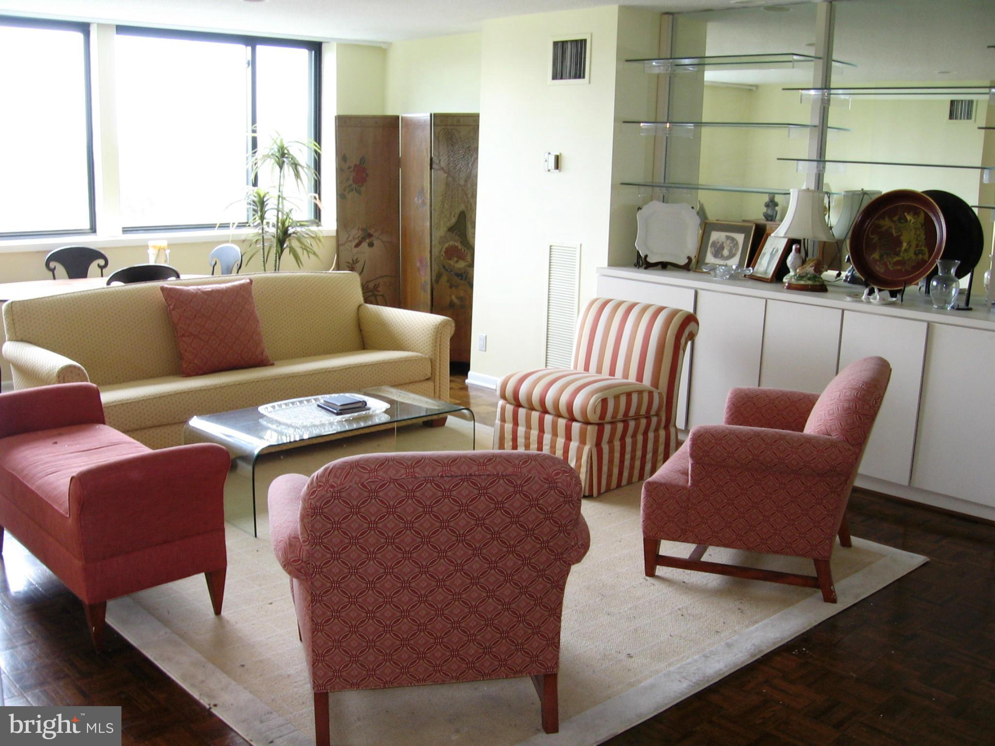 111 Hamlet Hill Road, Unit 1304 Baltimore, MD 21210 - Photo 2 of 17 a living room with furniture and a fireplace
