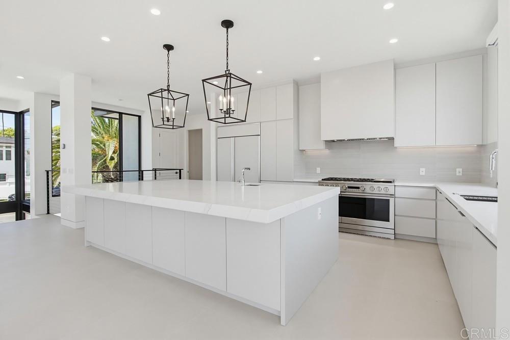 206 4th Street Encinitas, CA 92024 - Photo 16 of 64 a large kitchen with stainless steel appliances granite countertop a sink a stove and a refrigerator