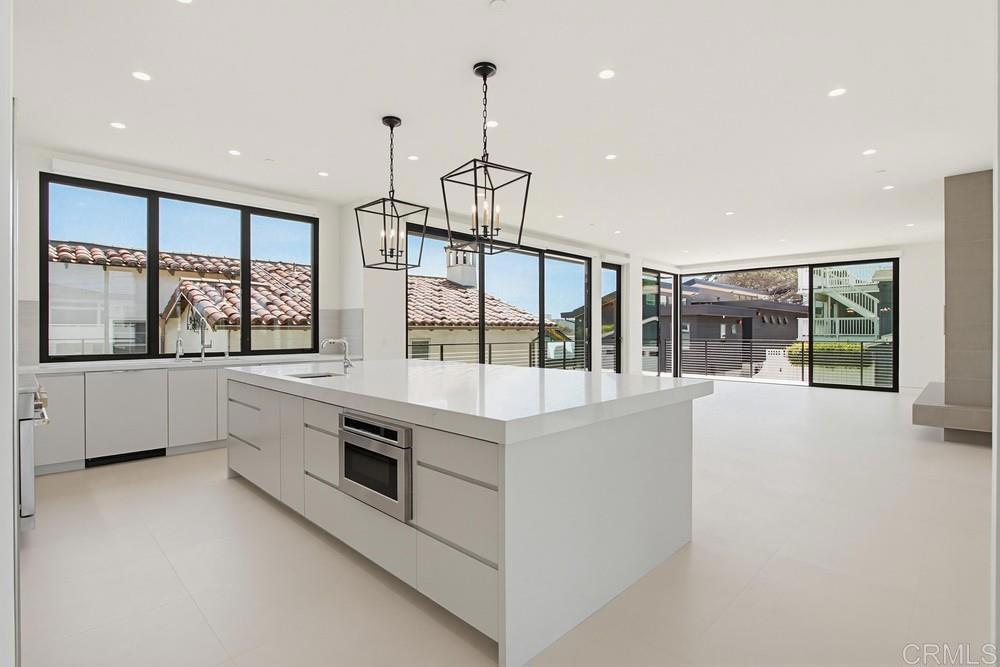 206 4th Street Encinitas, CA 92024 - Photo 21 of 64 a kitchen with stainless steel appliances granite countertop a stove and a large window