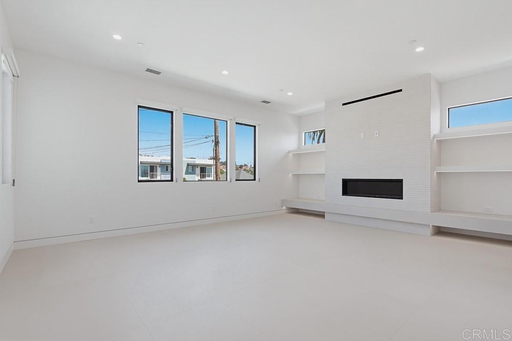 206 4th Street Encinitas, CA 92024 - Photo 26 of 64 an empty room with windows and fireplace