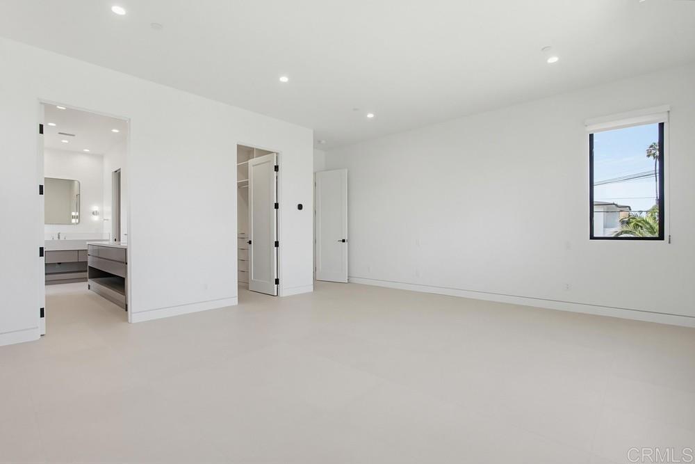 206 4th Street Encinitas, CA 92024 - Photo 29 of 64 an empty room with a white cabinet and a bathroom