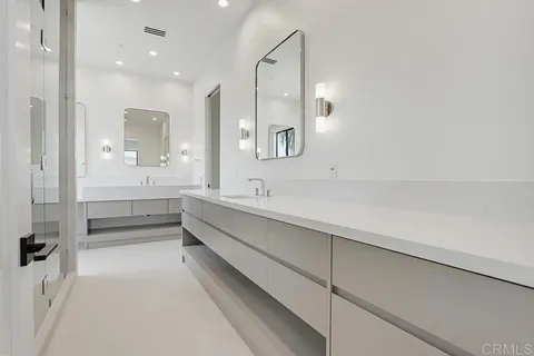 a bathroom with a granite countertop sink a toilet and shower