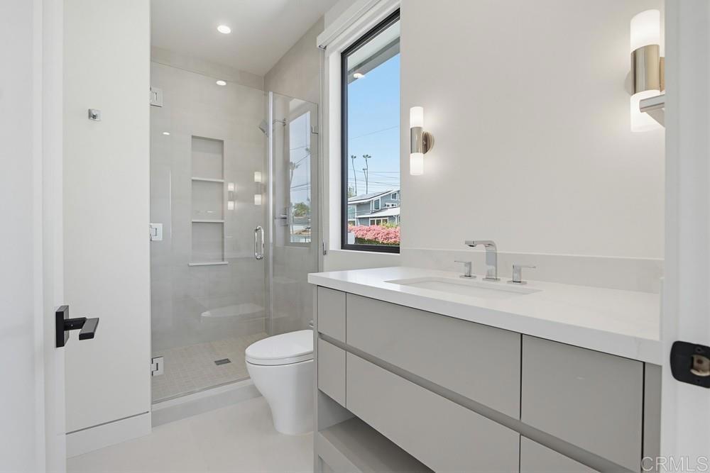 206 4th Street Encinitas, CA 92024 - Photo 39 of 64 a bathroom with a granite countertop sink a toilet and shower