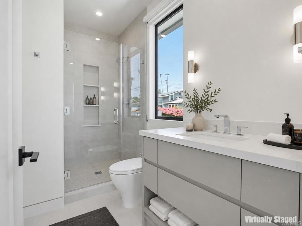206 4th Street Encinitas, CA 92024 - Photo 40 of 64 a bathroom with a granite countertop sink a toilet and shower