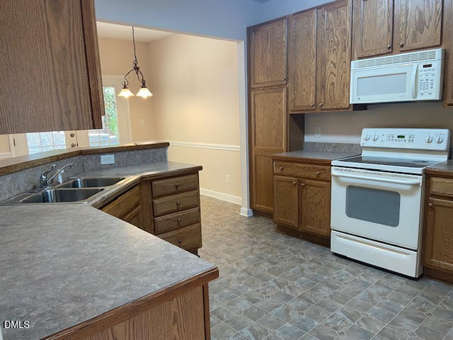 Undisclosed Address Raleigh, NC 27610 - Photo 5 of 14 a kitchen with stainless steel appliances granite countertop a sink and cabinets