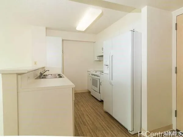 a utility room with cabinets washer and dryer