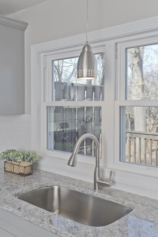90 Darling Street Springfield, MA 01151 - Photo 11 of 42 a kitchen with a sink a counter space and a window