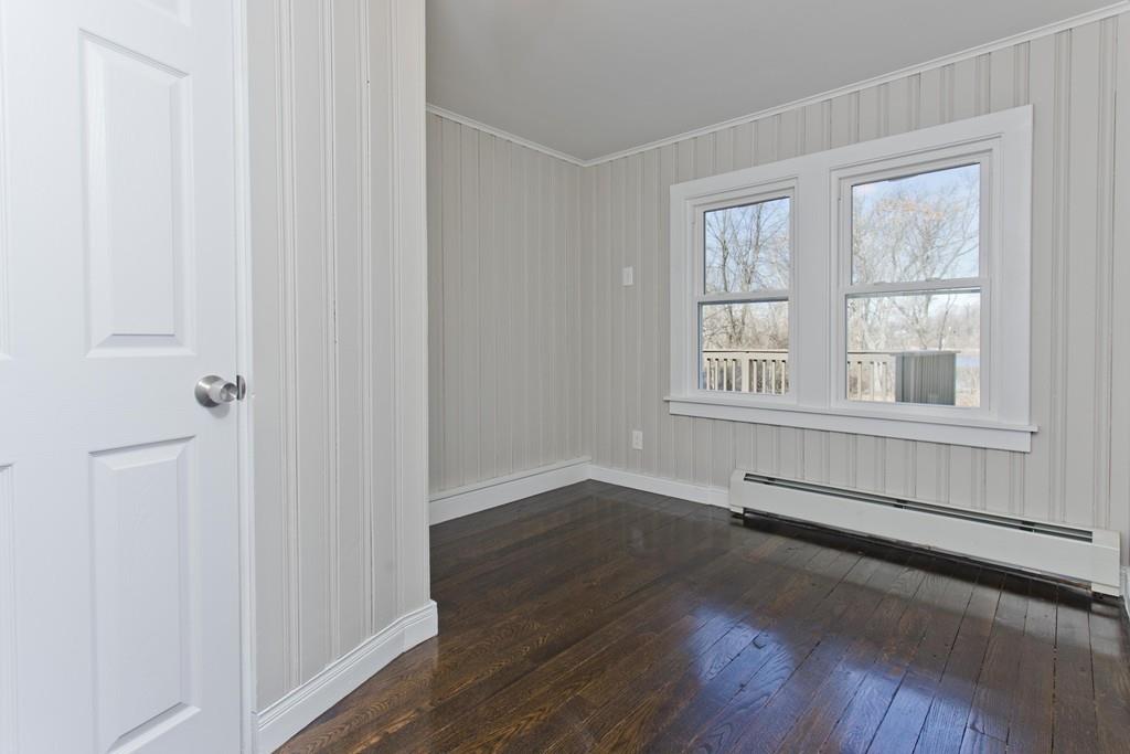 90 Darling Street Springfield, MA 01151 - Photo 25 of 42 an empty room with wooden floor and windows