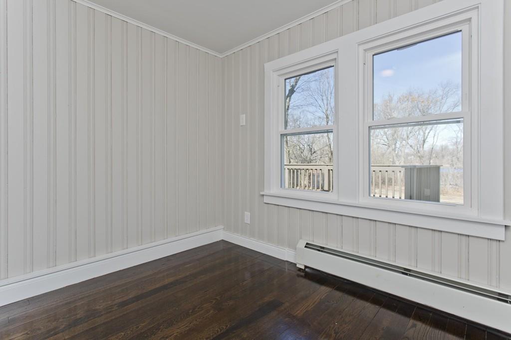 90 Darling Street Springfield, MA 01151 - Photo 26 of 42 a view of an empty room with wooden floor and a window