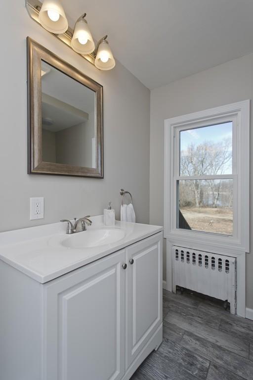 90 Darling Street Springfield, MA 01151 - Photo 27 of 42 a bathroom with a sink a large mirror and a window