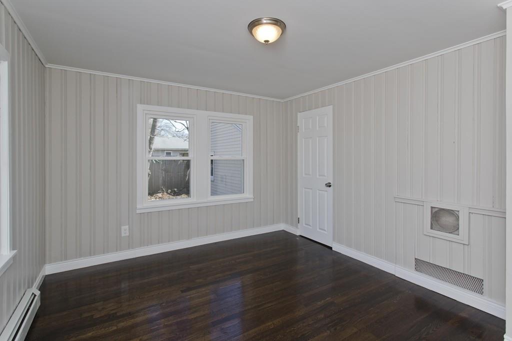 90 Darling Street Springfield, MA 01151 - Photo 34 of 42 a view of an empty room with wooden floor and a window