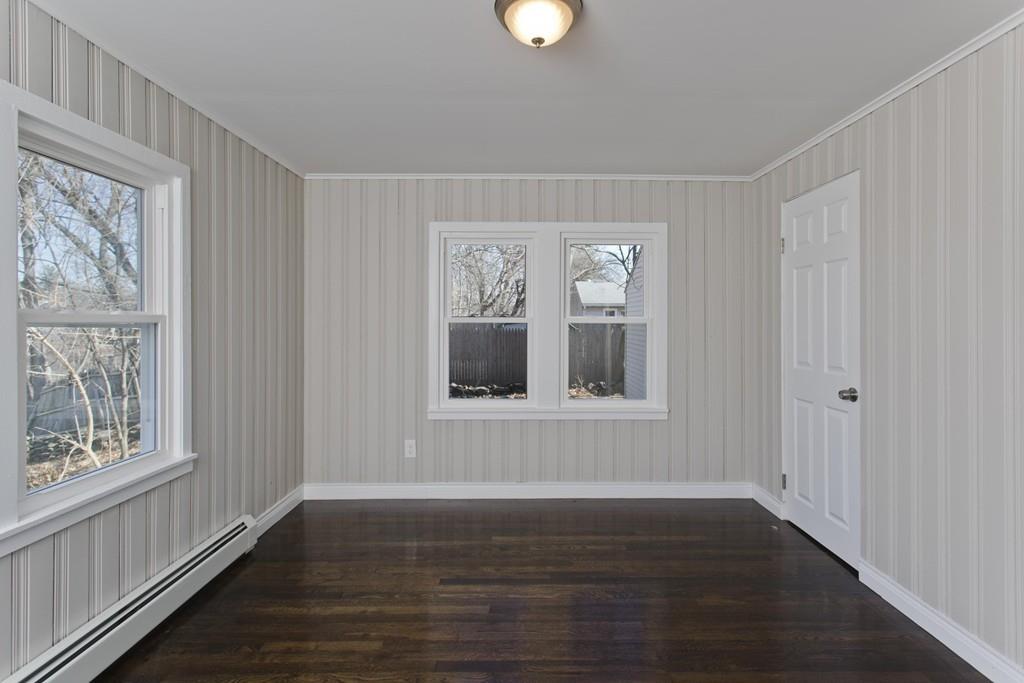 90 Darling Street Springfield, MA 01151 - Photo 35 of 42 a view of an empty room with wooden floor and a window