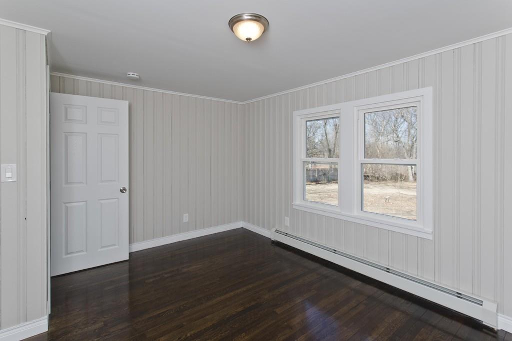 90 Darling Street Springfield, MA 01151 - Photo 36 of 42 an empty room with wooden floor and windows