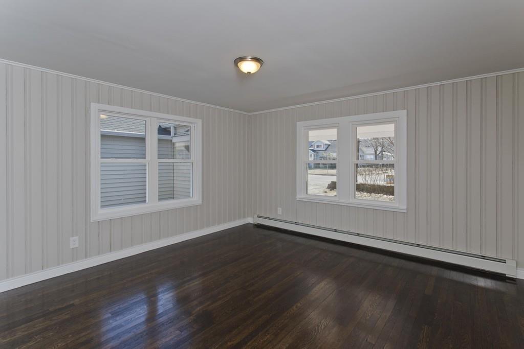 90 Darling Street Springfield, MA 01151 - Photo 38 of 42 a view of an empty room with wooden floor and a window