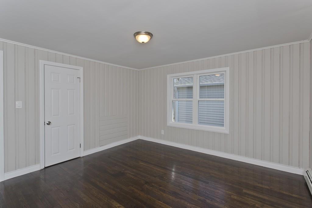 90 Darling Street Springfield, MA 01151 - Photo 39 of 42 a view of an empty room with wooden floor and a window