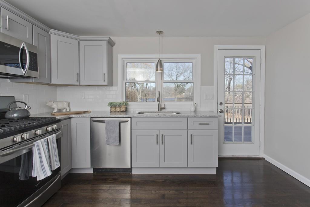 90 Darling Street Springfield, MA 01151 - Photo 6 of 42 a kitchen with granite countertop white cabinets and stainless steel appliances