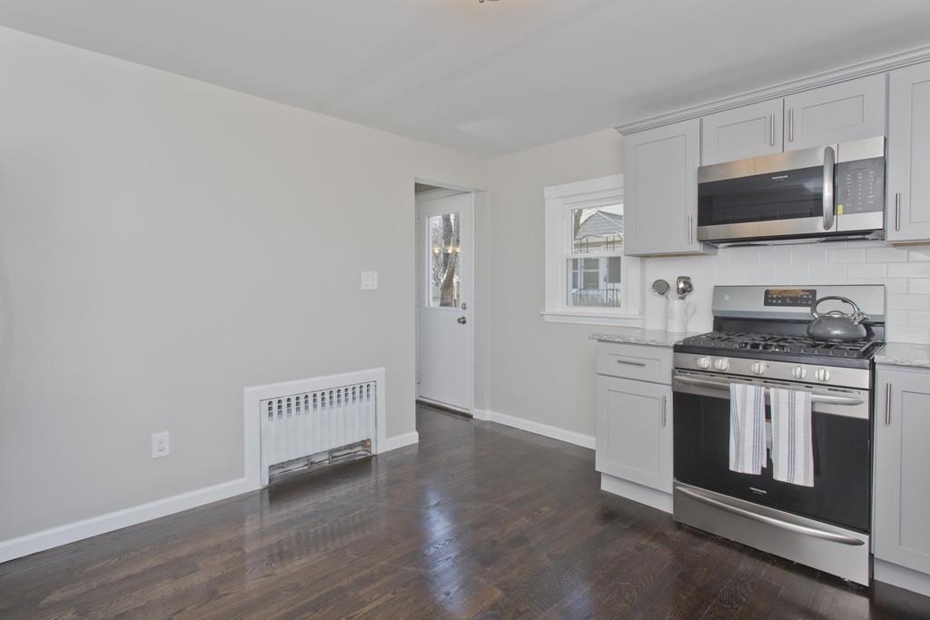 90 Darling Street Springfield, MA 01151 - Photo 7 of 42 a kitchen with stainless steel appliances granite countertop a stove a microwave and a refrigerator