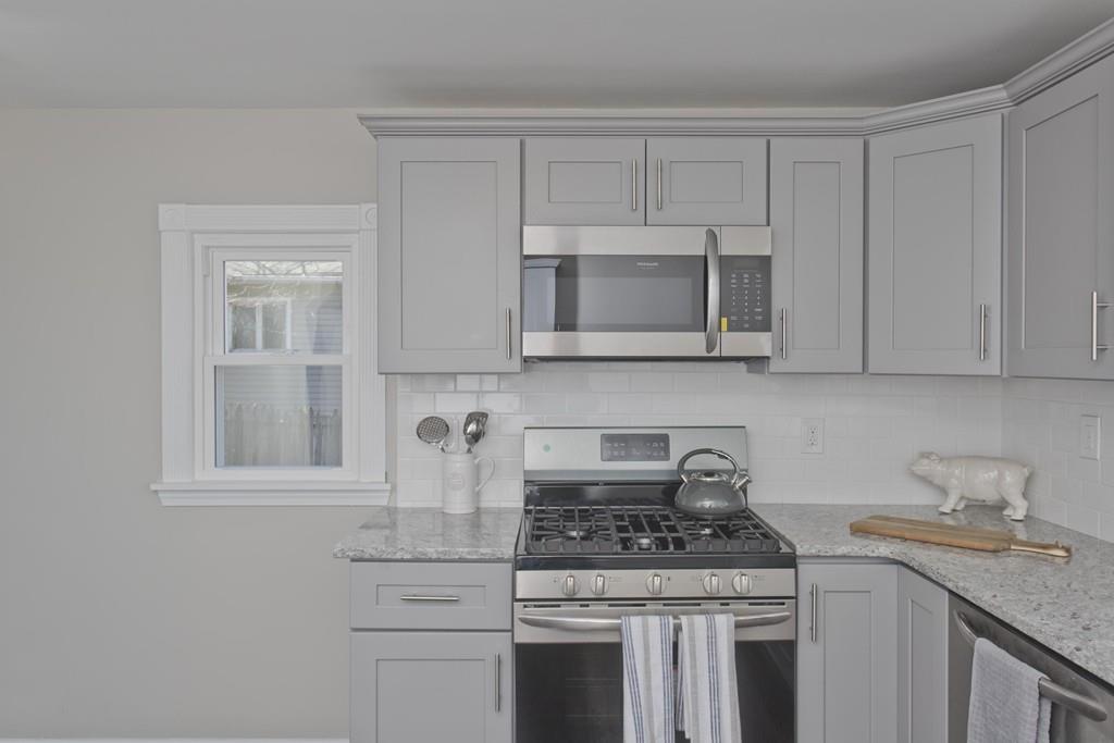 90 Darling Street Springfield, MA 01151 - Photo 8 of 42 a kitchen with granite countertop white cabinets and stainless steel appliances