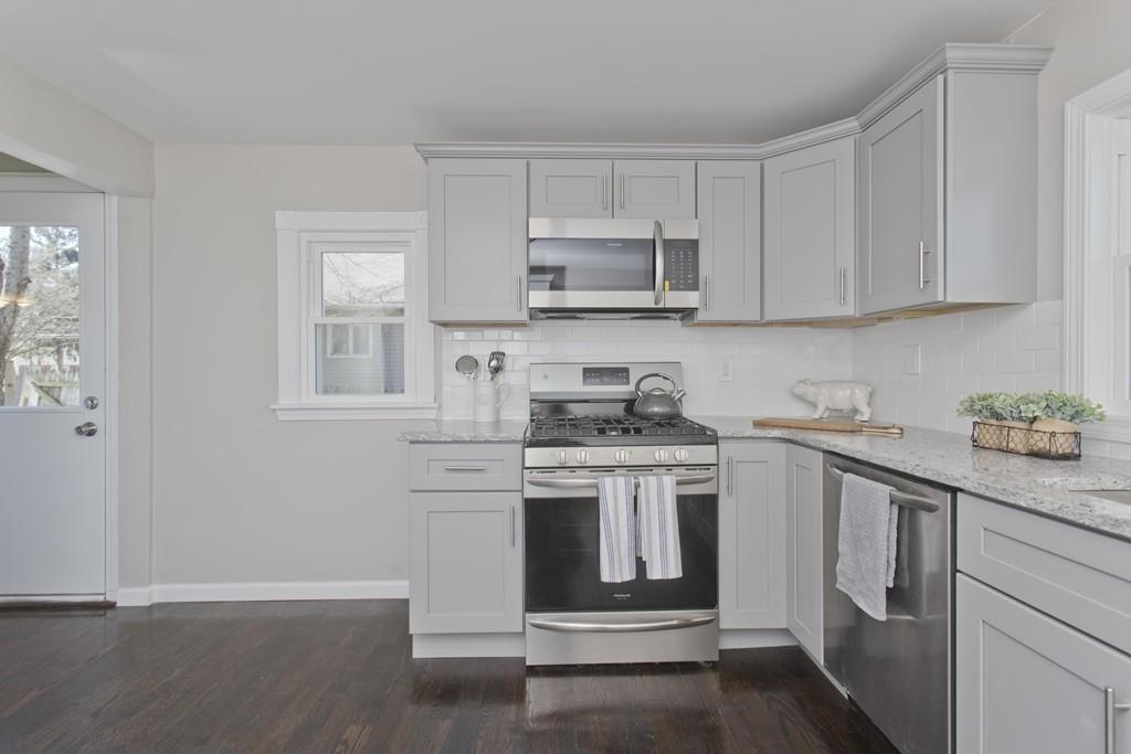 90 Darling Street Springfield, MA 01151 - Photo 9 of 42 a kitchen with stainless steel appliances granite countertop a stove and white cabinets