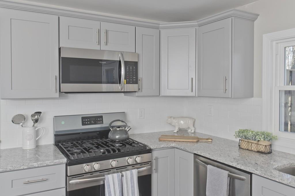 90 Darling Street Springfield, MA 01151 - Photo 10 of 42 a kitchen with granite countertop a sink stove and cabinets