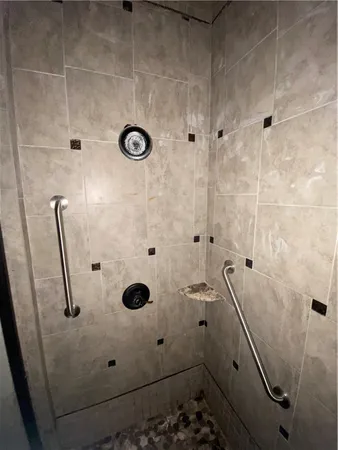a bathroom with a granite countertop sink a toilet and a mirror