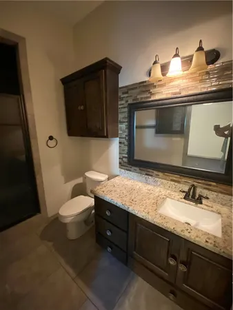 a bathroom with a toilet and shower