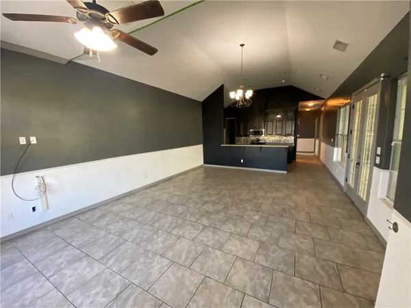 a view of a livingroom with a ceiling fan and window