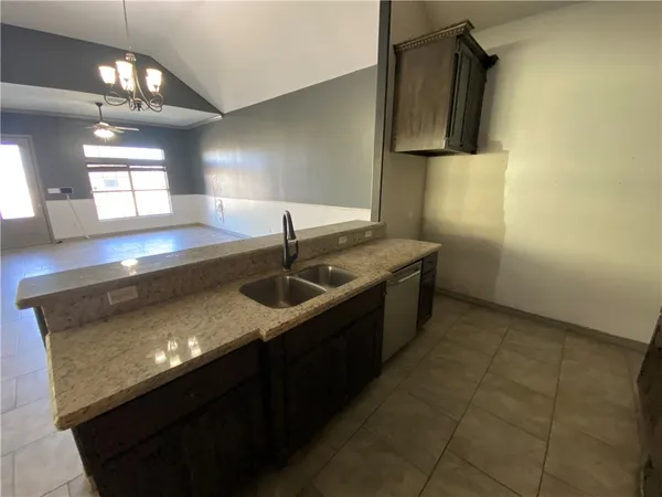a kitchen with a sink a counter top space and cabinets