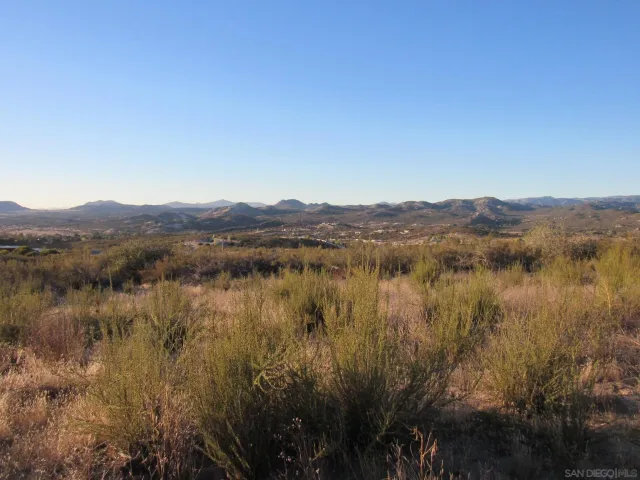 a view of lake with mountain and trees