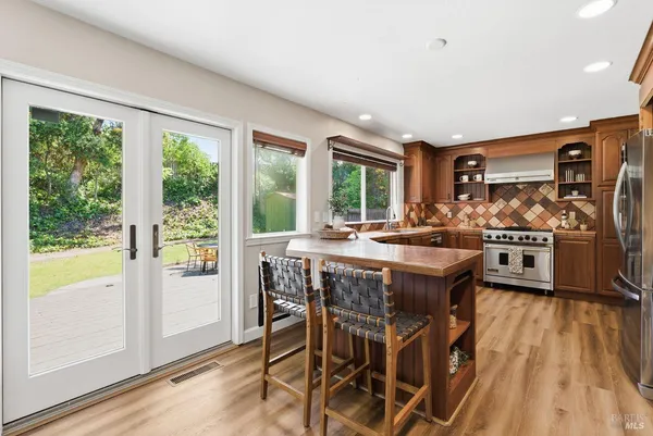 a kitchen with stainless steel appliances granite countertop a sink and wooden cabinets