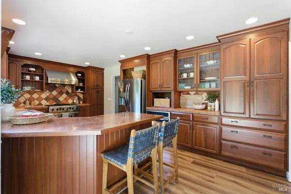 a stove top oven sitting inside of a kitchen